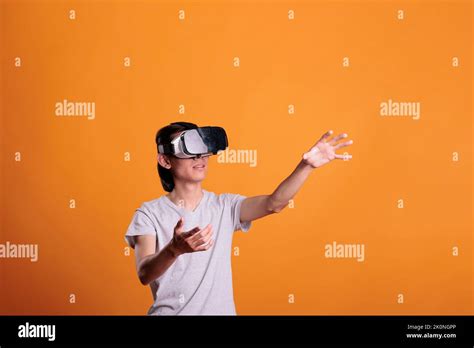 Man Playing Virtual Reality Games In Vr Goggles Exploring Metaverse