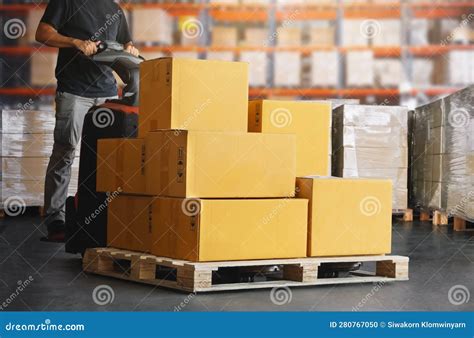 Workers Unloading Package Boxes On Pallets In Warehouse Electric