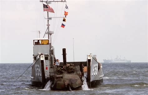 A Marine M1a1 Main Battle Tank Backs Out Of The Water Up The Ramp Of Utility Landing Craft Lcu