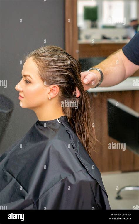 Young Woman With Wet Long Hair Receiving Hairstyle In A Hair Salon