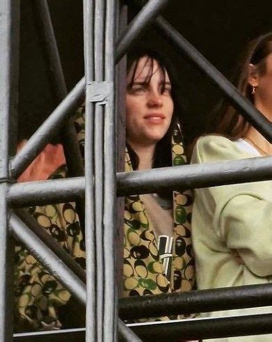 Two Women Looking Out The Window Of A Building