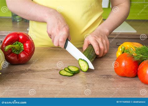 Woman Cutting Cucumber For Salad Fresh Vegetables Concept Stock Image