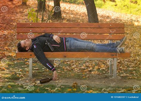 A Drunk Young Man Sleeping On A Bench In The Day Stock Image Image Of