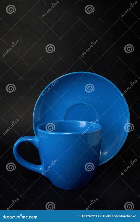 Light Blue Cup Of Coffee And Saucer On A Black Background Stock Image