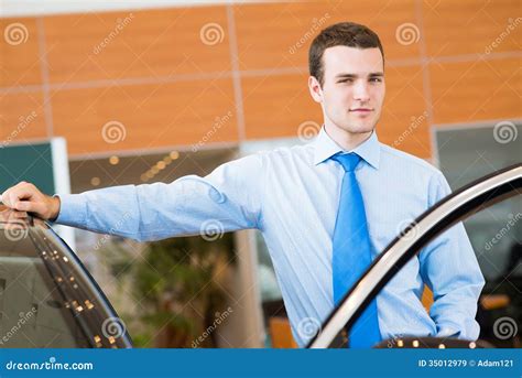 Dealer Stands Near a New Car in the Showroom Stock Image - Image of ...