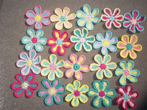 Crocheted Flowers Are Arranged On The Table