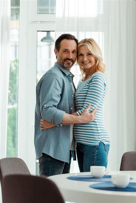 Mature Man Hugging Wife Near Curtains Stock Photo Image Of Couple Husband