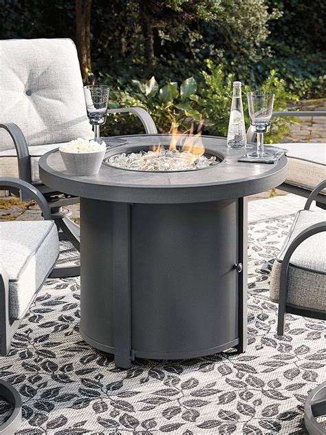 Donnalee Bay Outdoor Round Fire Pit Table By Signature Design By Ashley