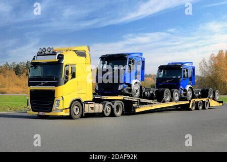 Yellow Volvo Fh Vehicle Carrier Truck Carrying Two New Green And Red