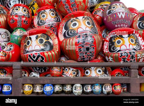 A Group Of Traditional Japanese Daruma Dolls Piled Up At Shorinzan