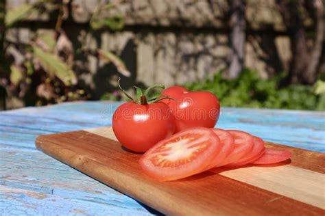 Juicy Closeup Of Ripe Red Vine Ripened Tomatoes Sliced And Whole Stock