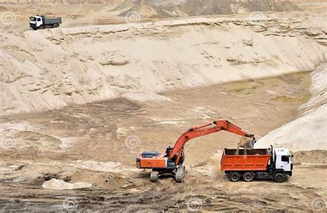 Excavator Load The Sand To The Heavy Dump Truck In The Open Pit Heavy Machinery Working In The