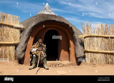 Basotho Man In Front Of Traditional Hut Thaba Bosiu Cultural Village