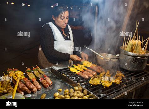 Cuenca, Ecuador - Street food vendor prepares shish kabob of sausage ...