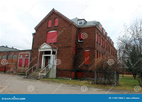 Exterior Of Boarded Up And Abandoned Brick Asylum Hospital Building