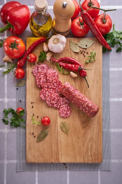 Premium Photo Sliced Salami Sausage On Wooden Cutting Board At