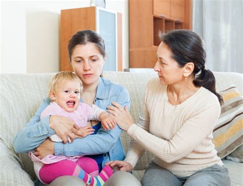 Mature Woman Comforting Daughter With Baby A Stock Image Image Of