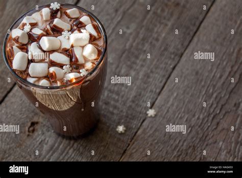 Winter Hot Cocoa With Marshmallows Chocolate Syrup Sugar Snowflakes In A Tall Glass On A