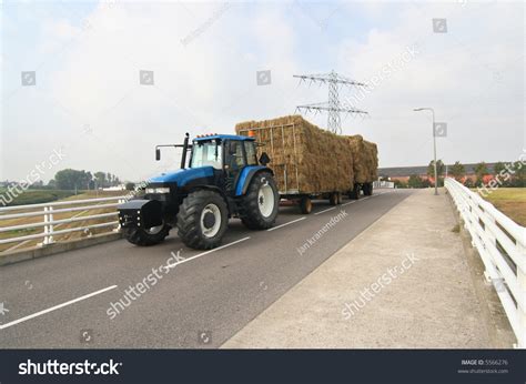 Tractor Pulling A Trailer With Hay Across A Bridge Stock Photo 5566276 : Shutterstock