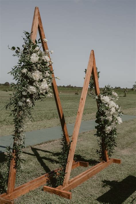 Triangle Wedding Ceremony Arch With Flowers Greenery Wedding Outdoors