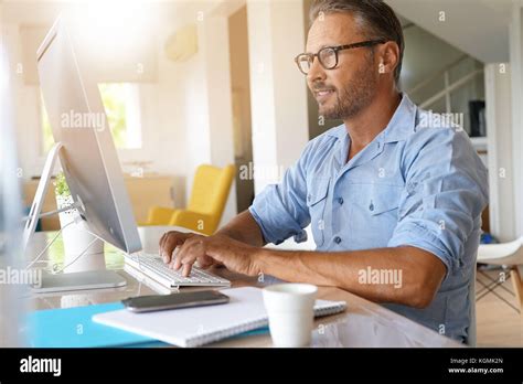 Mature Man Working From Home On Desktop Computer Stock Photo Alamy