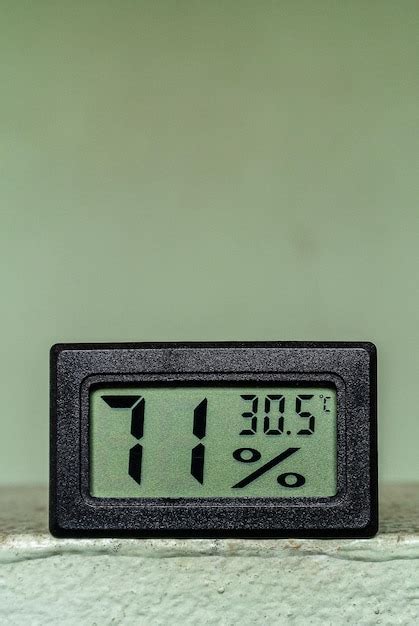 Premium Photo Digital Thermometer And Hygrometer On The Green Background