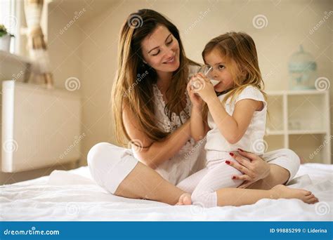 Mother With Her Daughter Enjoying In Bed Together Stock Image Image