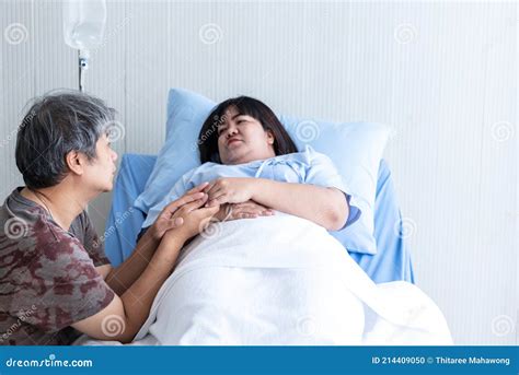 Asian Middle Aged Husband Holding Hand His Wife To Encourage Stock