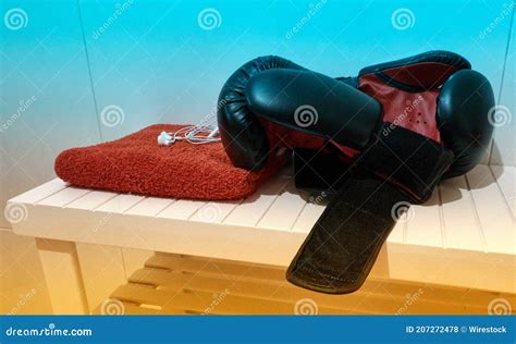 Shot Of Boxing Gloves Towel And Earbuds On The Table A Healthy