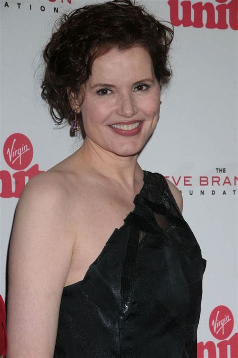 A Woman In A Black Dress Smiling For The Camera On A Red Carpeted Area