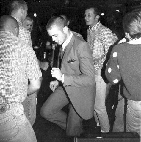 Black And White Photograph Of Man In Suit Dancing With Other People