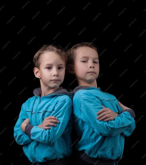 Premium Photo Portrait Of Adorable Twin Boys Isolated On Black