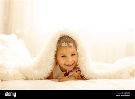 Little toddler child, cute kid with knitted small cute animal toy ...