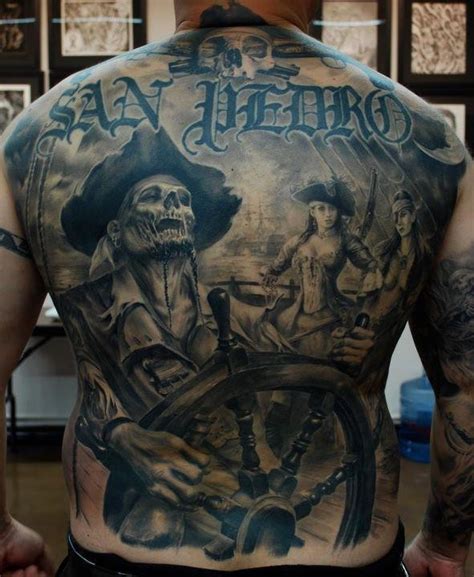 Cool pirate skeleton at the helm tattoo on back - Tattooimages.biz