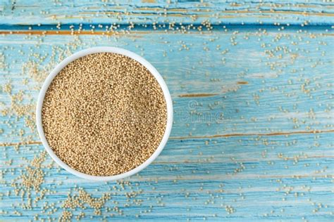 Raw Organic Amaranth Seeds In Bowl Isolated On Wooden Table Top View