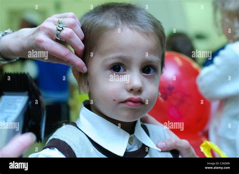 Shalev, Young Jewish boy of three having his first ritual haircut ...