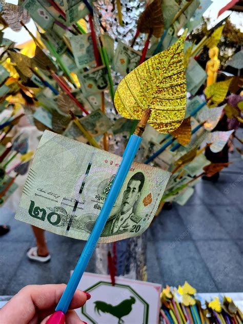 Premium Photo A Banknote Of 20 Thai Baht As A Donation At A Buddhist