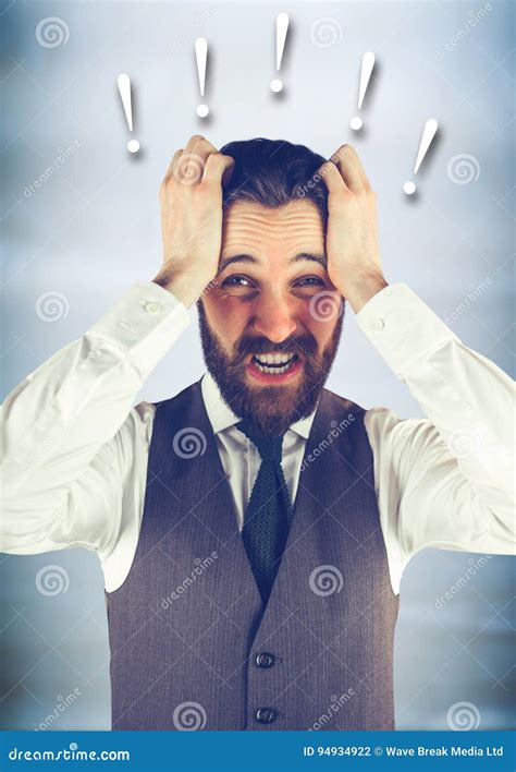 Frustrated Business Man Against Blurry Blue Wood Panel And Exclamation