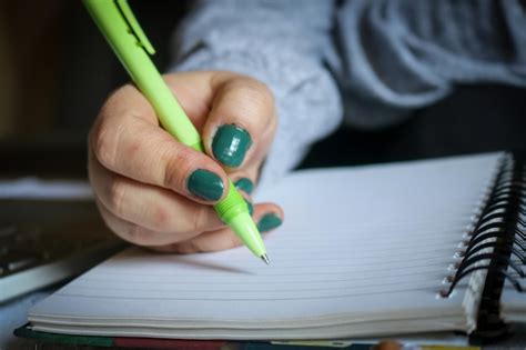 Premium Photo Cropped Hand Writing In Book