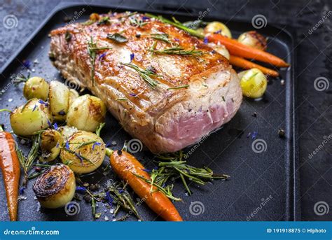 Traditional Roasted Dry Aged Veal Tenderloin With Carrots And Onions On