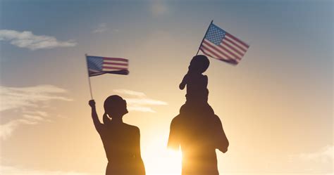 Patriotic Man Woman And Child Waving American Flags In The Air J