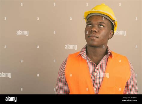 Young African Man Construction Worker Against White Background Stock