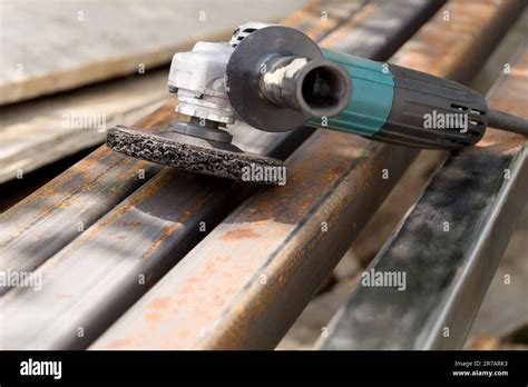 electric angle grinder tool lies   rust metal square tube