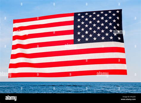 Beautiful Patriotic Woman With American Flag On The Beach Usa