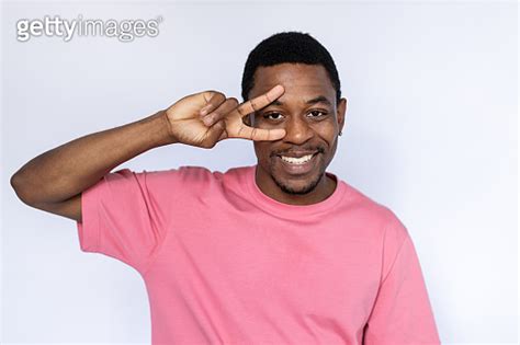 Portrait Of Happy African American Man Showing Victory Sign 이미지