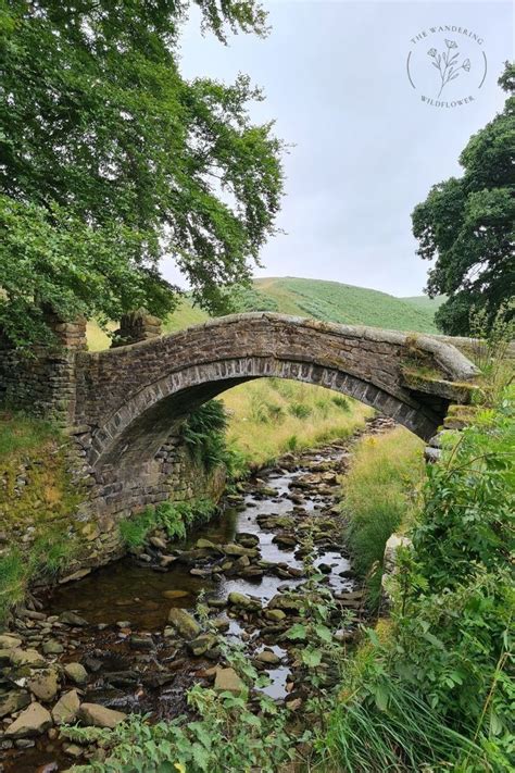 An Old Stone Bridge Over A Small Stream