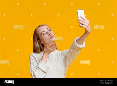 Coquette Girl Making Selfie On Smartphone And Sending Air Kiss Stock