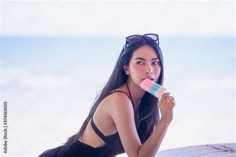 Sexy Asian Women Wearing Bikini For A Walk On The Beach On Vacation In The Evening Stock Photo