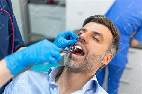 Premium Photo Treatment Of A Patient With A Dentist Surgeon