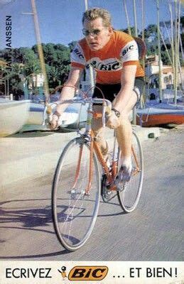 A Man Riding A Bike Down A Street